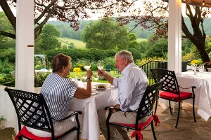 Couple toasting wine a beautiful outdoor settings - L&L Hospitality has Select Registry properties in Virginia and Florida